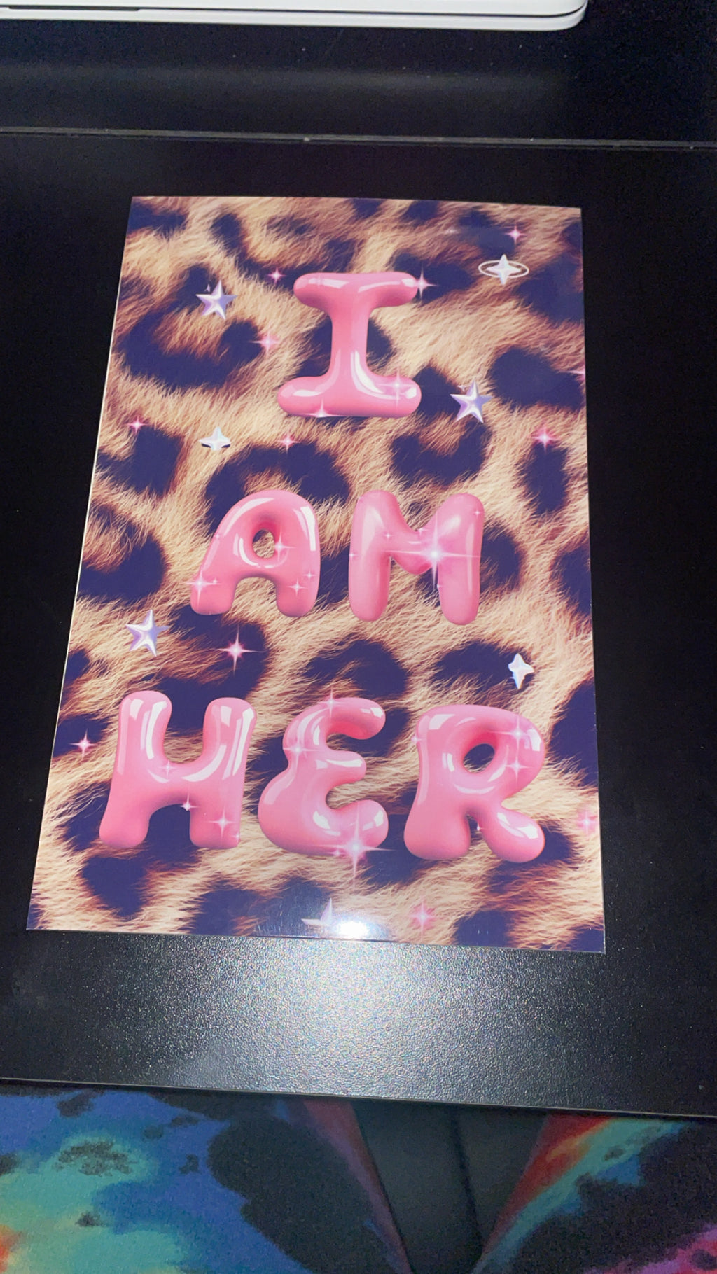Leopard print card with pink text 'I AM HER' on a black border.