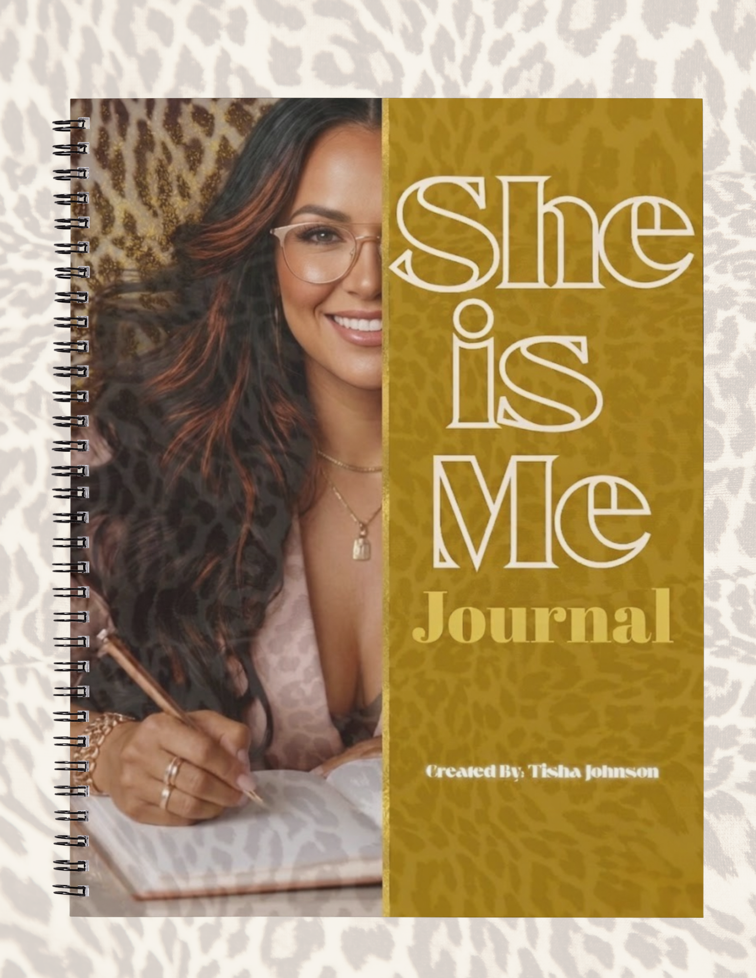 Journal with a woman's face and 'She is Me' text on a textured background