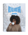 Journal with a design of a person holding a mug and snowflakes.