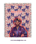 Notebook cover with a woman's portrait and decorative elements on a patterned background