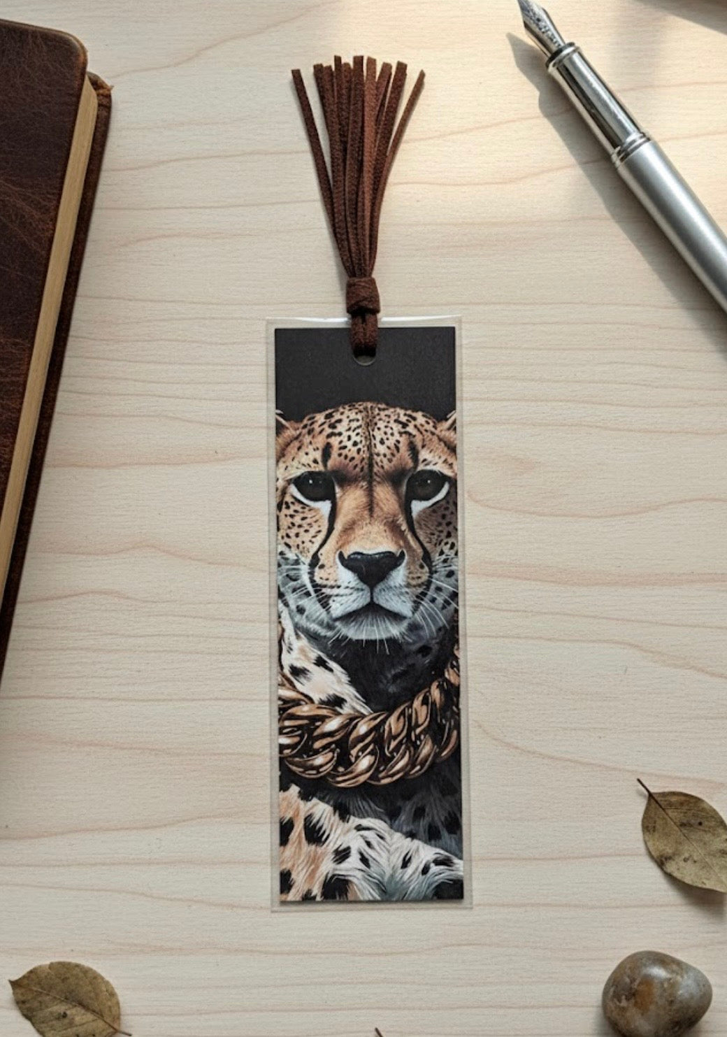 Leopard-themed bookmark with tassel on a wooden surface