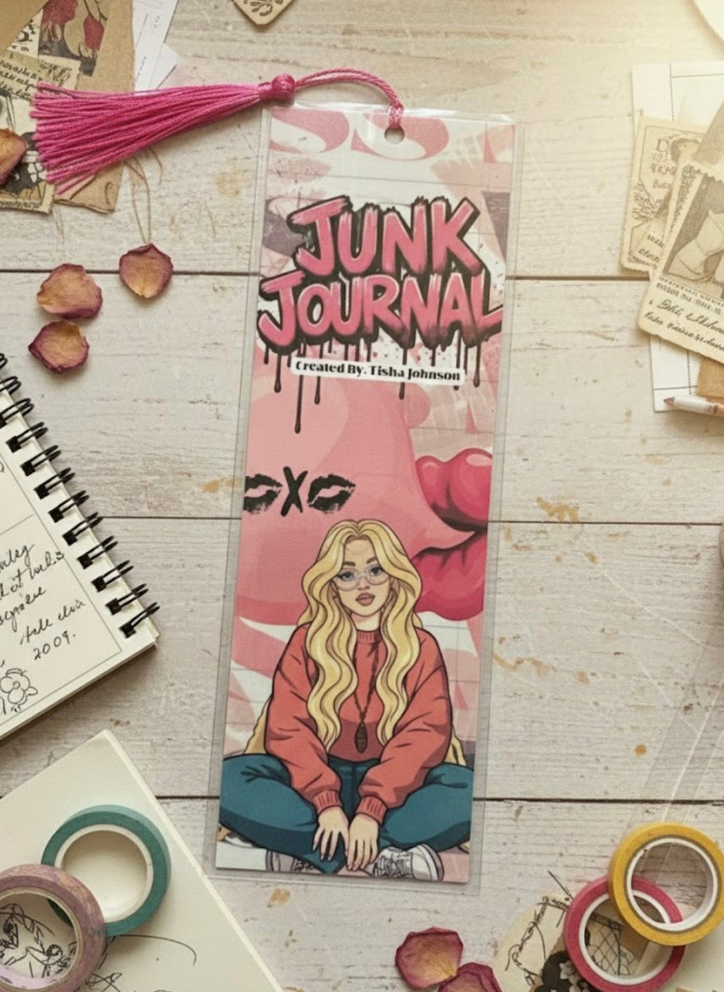 Junk Journal with a design of a girl sitting on a pink background, surrounded by stationery items.