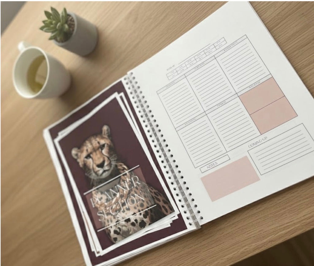 Open planner with a cheetah design on a wooden desk
