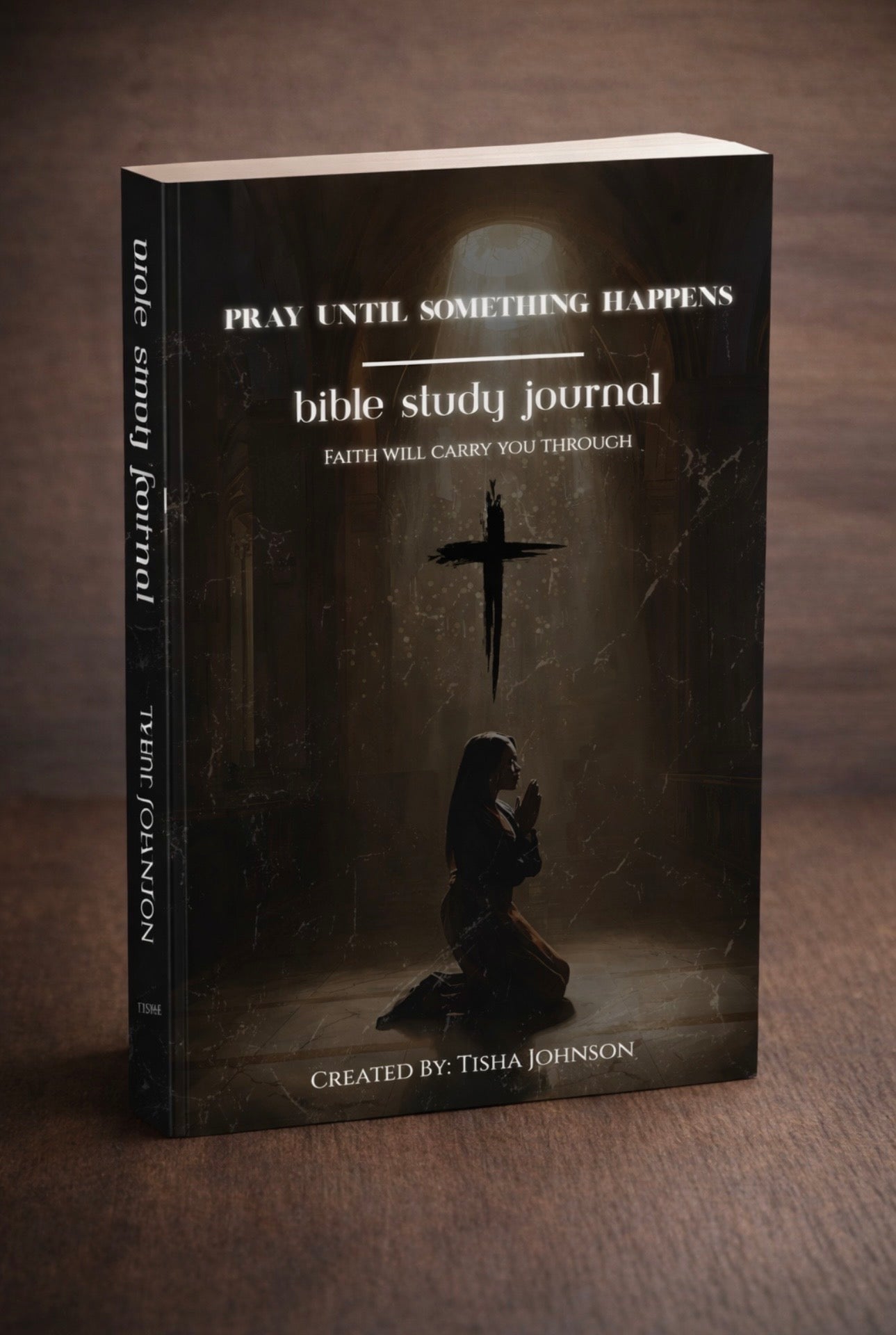 Bible study journal with a cross and praying person on a dark background