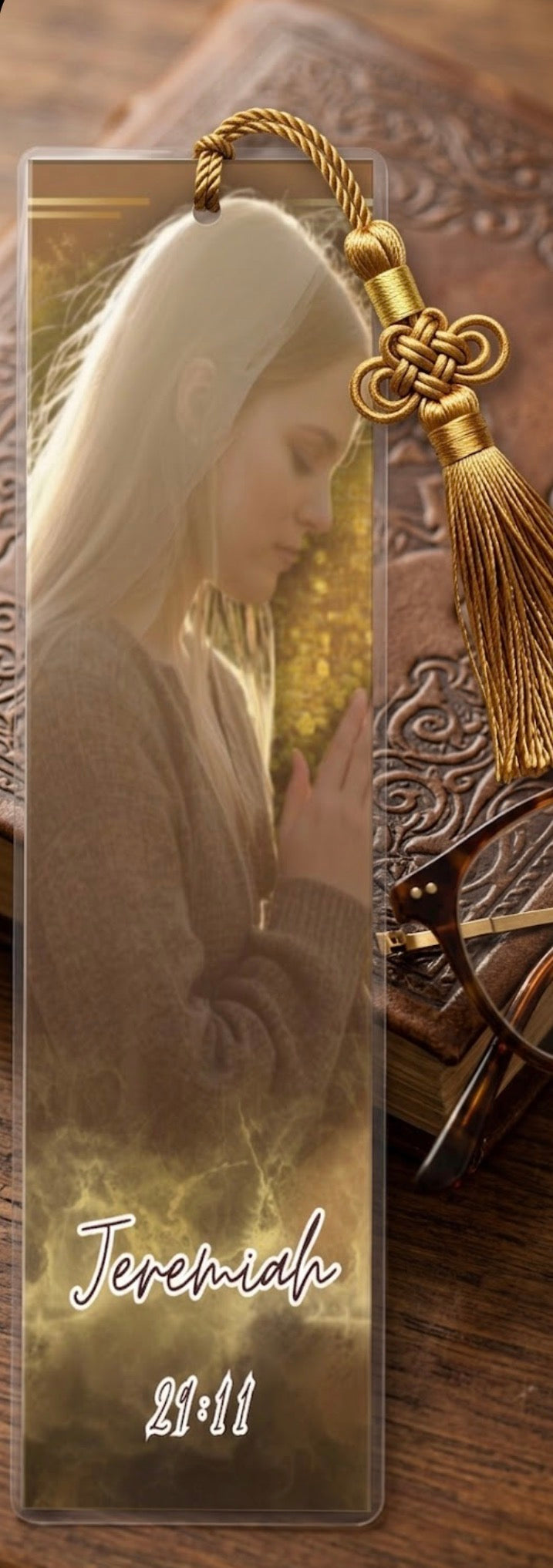 Bookmark with a religious design featuring a woman in prayer and the name 'Jeremiah 29:11'.