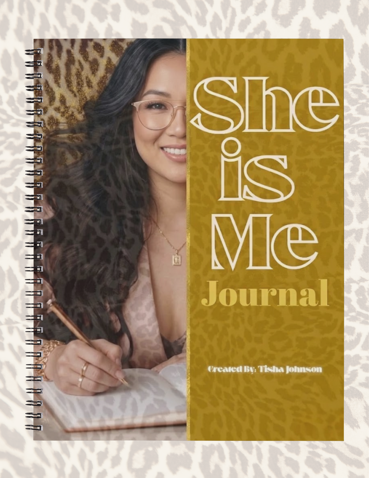Journal with a woman writing and text 'She is Me Journal' on a textured background
