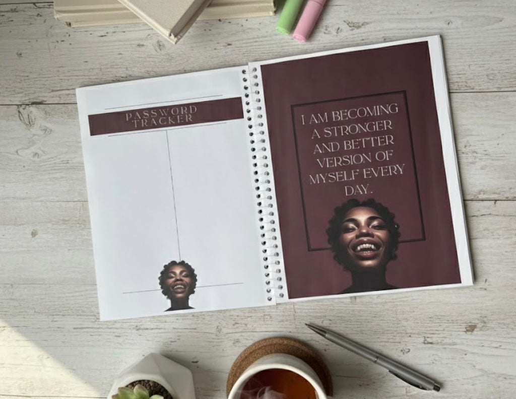 Open planner with motivational quote and password tracker on a wooden surface
