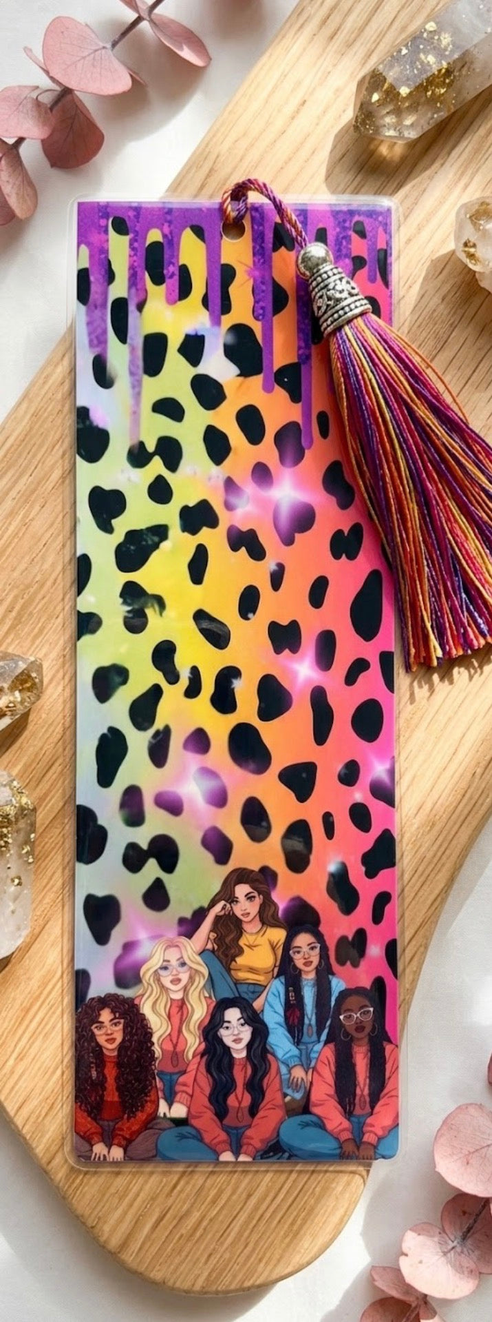 Colorful leopard print bookmark with tassel on a wooden surface