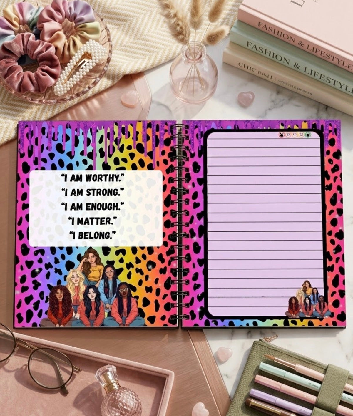 Notebook with colorful leopard print design and motivational quotes on a desk.