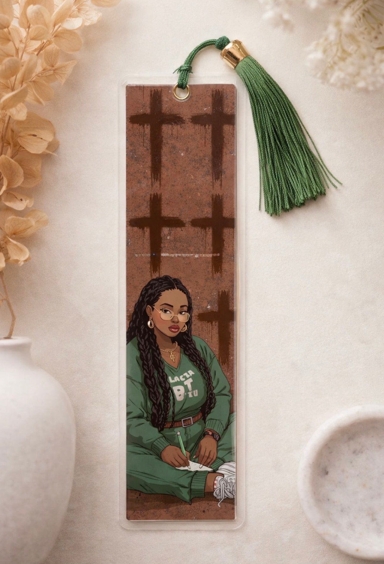 Bookmark with a portrait of a woman and decorative tassel on a neutral background