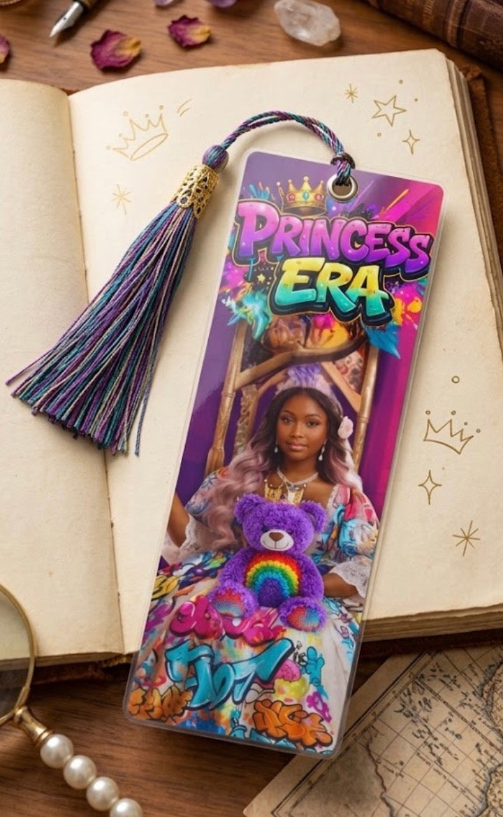 Colorful 'Princess Era' bookmark with a character holding a teddy bear and rainbow, placed on an open book.