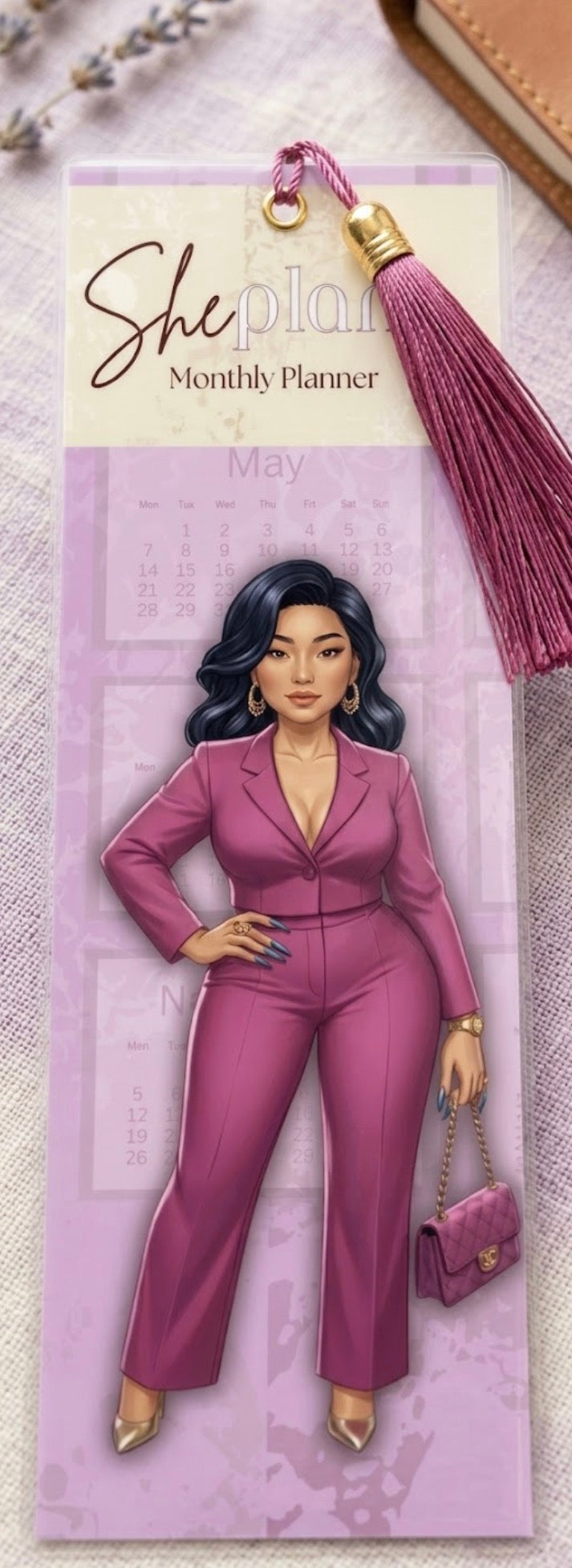 Bookmark with a woman in a pink suit and tassel on a light background